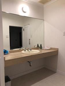 a bathroom with a sink and a large mirror at Sea Style Resort OCEAN in Karatsu