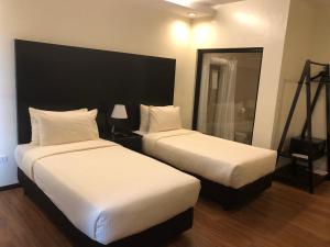 Postel nebo postele na pokoji v ubytování Piña Suites