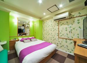 a bedroom with a bed and a desk and a computer at Hotel California Kaminarimon (Adult Only) in Tokyo