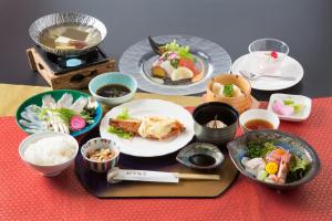 a table topped with plates and bowls of food at Hotel Keipu in Hakodate