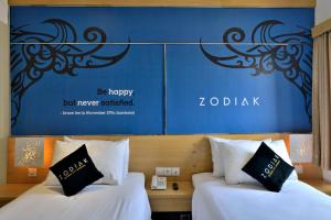 En eller flere senge i et værelse på Zodiak Kebon Jati by KAGUM Hotels