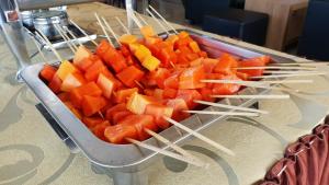 a tray of carrots on a table with chop sticks at Tulip Inn Tomohon in Tomohon