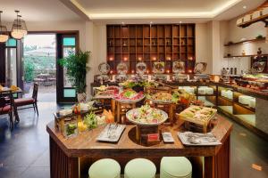 a buffet in a restaurant with many plates of food at RiverTown Hoi An Resort & Spa in Hoi An