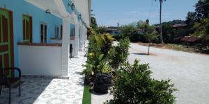 a courtyard of a house with plants in a yard at Mazza Nur Motel in Pantai Cenang