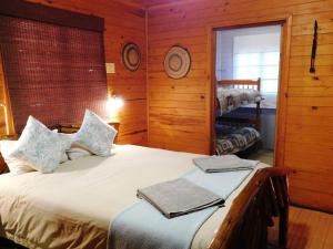 A bed or beds in a room at Isinkwe Bush Camp