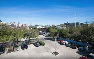 a parking lot with cars parked in a parking lot at Inviting 3BR Condo steps from St Charles Ave in New Orleans