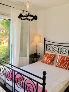 a bedroom with a bed with orange and white pillows at Villa Kiko in Mikri Vigla