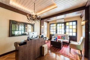 a living room with a desk and a couch at Gwandalan House in Dipolog