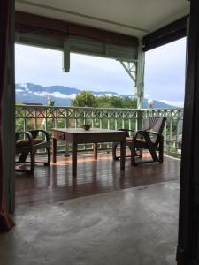 a table and two chairs on a porch with a view at Villa Duangchampa in Chiang Mai