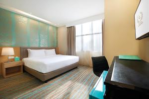 Postel nebo postele na pokoji v ubytování Cosmo Hotel Kuala Lumpur