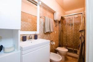 a bathroom with a sink and a toilet and a shower at Il balcone di Angelina in Isola del Liri +6 photos