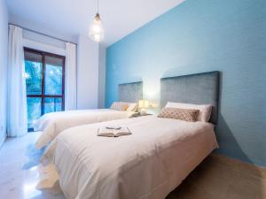 A bed or beds in a room at MALAGA CENTER EXPERIENCE - Premium Apartment