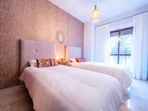 A bed or beds in a room at MALAGA CENTER EXPERIENCE - Premium Apartment