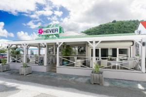 a restaurant with a keep sign on top of it at Hevea Hotel in Grand Case