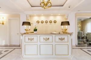 a room with a white dresser and a chandelier at Orchid Boutique Hotel in Tbilisi City