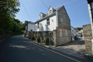a stone house on the side of a road at Althea House with parking in Padstow
