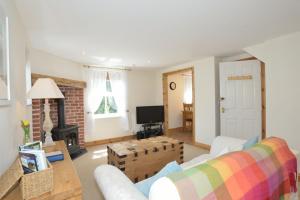 a living room with a couch and a fireplace at Althea House with parking in Padstow