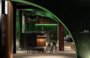 a green archway with a table and stools in a room at Art Zone 2 in Hualien City