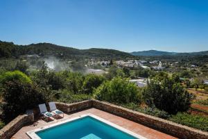 a swimming pool in a villa with a view at Villa Patri in Sant Carles de Peralta