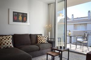 a living room with a couch and a balcony at Casa Andersen in Port de Pollensa