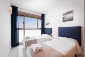 une chambre avec deux lits et une grande fenêtre dans l'établissement Apartamento Benidorm de Luxe, à Benidorm 8 autres photos
