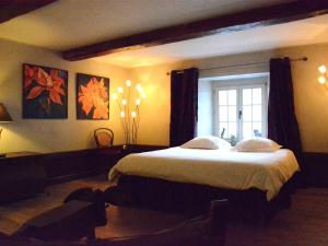 a bedroom with a large bed and a window at Holiday Home in Bièvre with Terrace in Bièvre