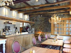 a kitchen with wooden tables and chairs in a room at Holiday Home in Bièvre with Terrace in Bièvre