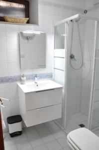 a white bathroom with a sink and a shower at Da Marzietta in Assisi +62 photos
