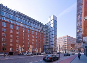 a city street with tall buildings and a car at GINN Hotel Hamburg Elbspeicher in Hamburg