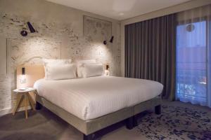 Een bed of bedden in een kamer bij Néméa Appart'Hôtel Cannes Palais