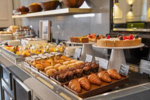 a buffet with many different types of pastries and cakes at H10 Palazzo Canova in Venice