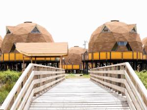 a bridge leading to a building with domes at Chiloe Domos Curaco de Vélez in Curaco de Velez