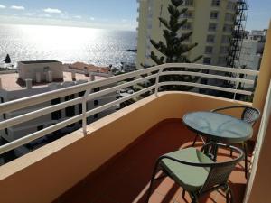 a balcony with chairs and a view of the ocean at Lido Funchal Apartment balcony sea view in Funchal