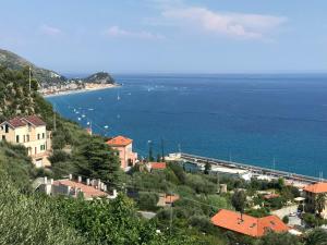 a town on a hill with a view of the ocean at Gioia Bed and Breakfast in Finale Ligure