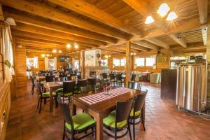 a restaurant with wooden ceilings and tables and chairs at Drevenica Viki in Terchová