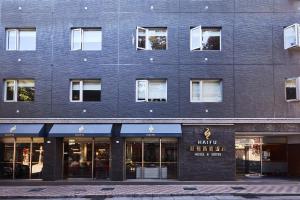 a black brick building with a store front at Hai Fu Hotel & Suites in Jincheng