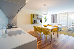 a kitchen and living room with a table and chairs at Deluxe Apartments Opatija in Opatija
