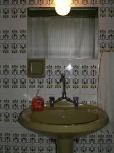 a bathroom with a green sink and a window at The Ideal House In The City Center in Veria
