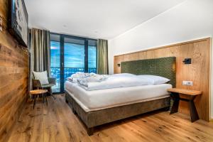Posteľ alebo postele v izbe v ubytovaní Berghotel Schmittenhöhe - 2000m