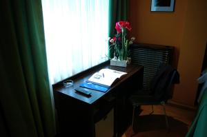 a desk with a laptop on it next to a window at Hotel Gran Via in Zaragoza