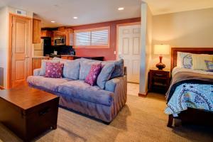 a living room with a couch and a bed at Cabana #11 in Chelan