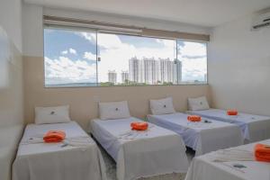 Giường trong phòng chung tại Hotel Cco Goiânia