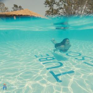 a woman in the water with numbers in the water at Tube Resort in Koh Rong Sanloem