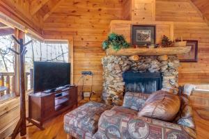 a living room with a fireplace and a tv at Majestic View #42B in Sevierville