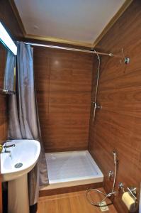 a bathroom with a shower, sink, and toilet at Norte Guest House in Lisbon