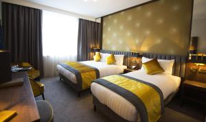 Voodi või voodid majutusasutuse Iveagh Garden Hotel toas