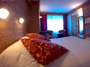 Postelja oz. postelje v sobi nastanitve Hotel le Chalet