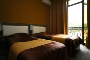Voodi või voodid majutusasutuse Discovery Hotel toas