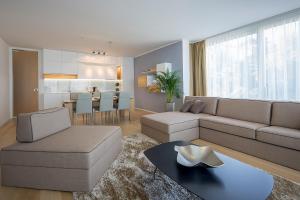 a living room with a couch and a table at Deluxe Apartments Opatija in Opatija