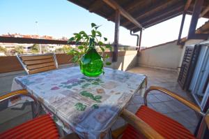 a green vase sitting on a table on a balcony at GALANT apartments in Rovinj